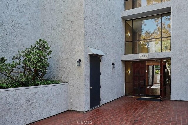 3601 W Hidden Ln Unit 121, Rolling Hills Estates, CA 90274 - doorway to property featuring stucco siding