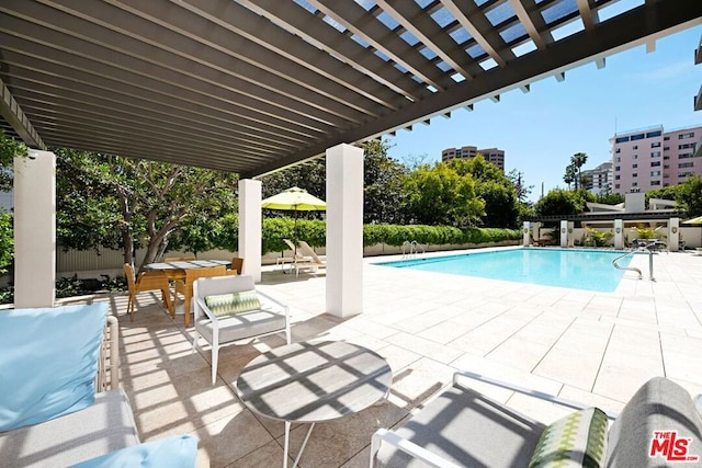 view of swimming pool featuring a pergola and a patio area