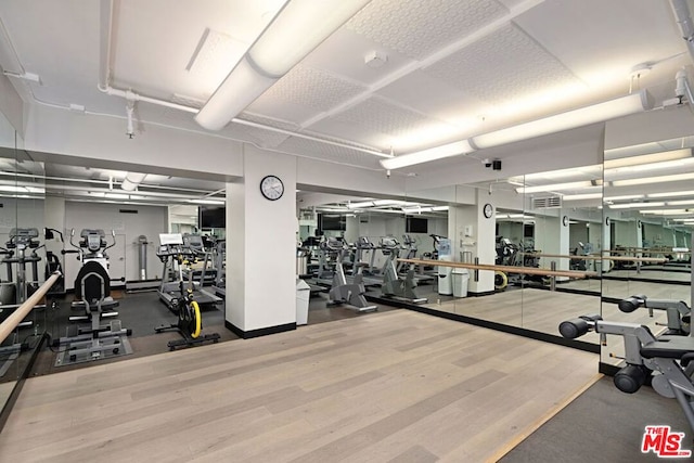 gym with hardwood / wood-style floors