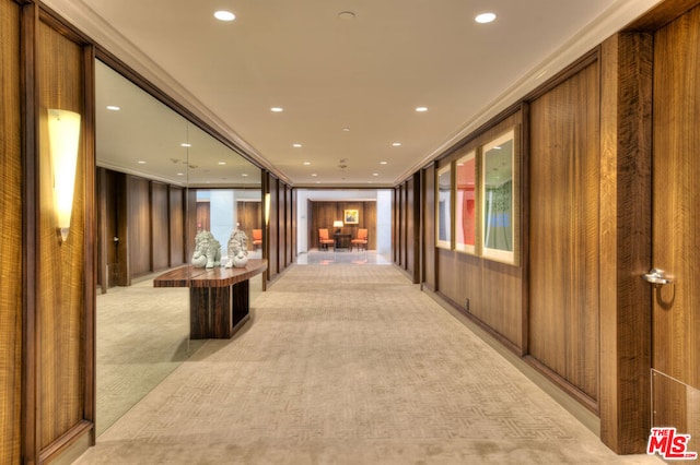 hall featuring light carpet and ornamental molding