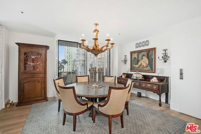 dining area featuring a chandelier and light hardwood / wood-style flooring