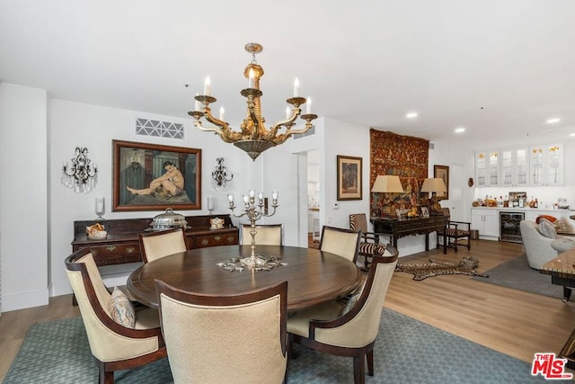 dining area featuring bar, a notable chandelier, dark wood-type flooring, and beverage cooler