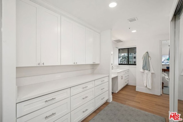 interior space with hardwood / wood-style floors and vanity