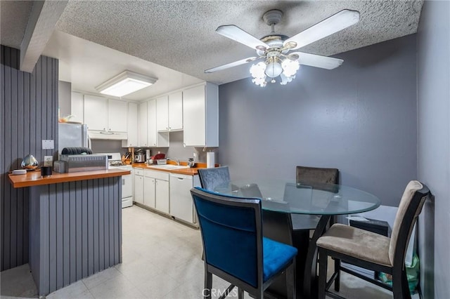 kitchen featuring white cabinetry, sink, white appliances, and butcher block countertops