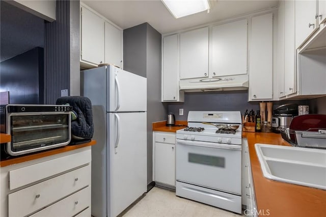 kitchen with white cabinetry, white appliances, and sink