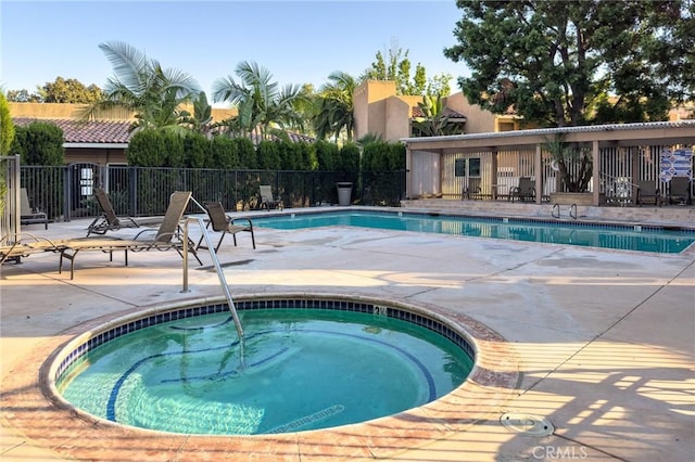 view of pool featuring a hot tub and a patio area