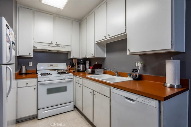 kitchen with white cabinetry, sink, and white appliances