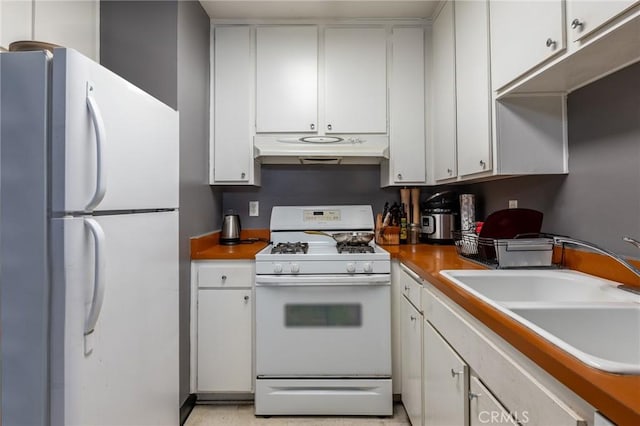 kitchen with white cabinetry, sink, and white appliances