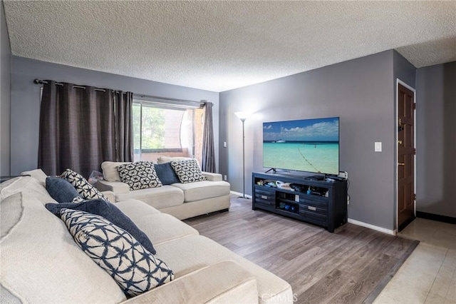 living room featuring hardwood / wood-style floors and a textured ceiling