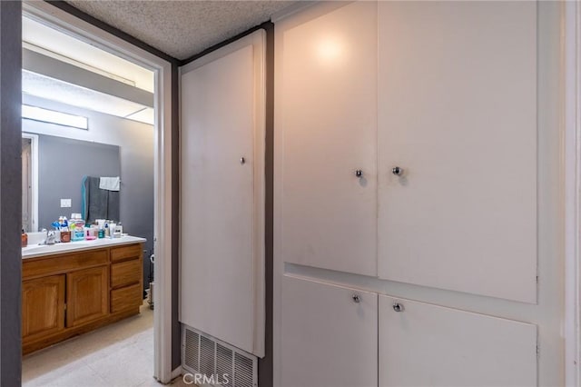 bathroom featuring vanity and a textured ceiling