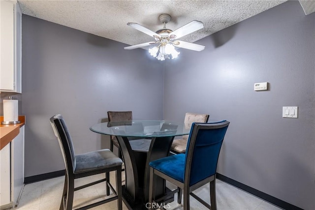 dining room with ceiling fan and a textured ceiling