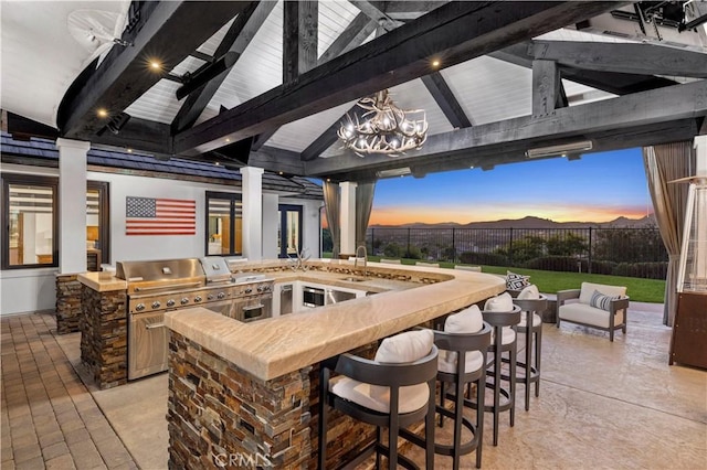 view of patio with a gazebo, area for grilling, outdoor wet bar, and fence