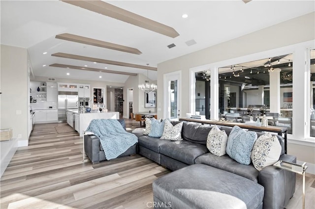 living room with visible vents, lofted ceiling, recessed lighting, a notable chandelier, and light wood-type flooring