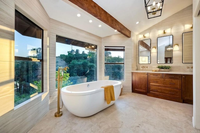 bathroom featuring a bath, tile walls, vaulted ceiling with beams, and vanity