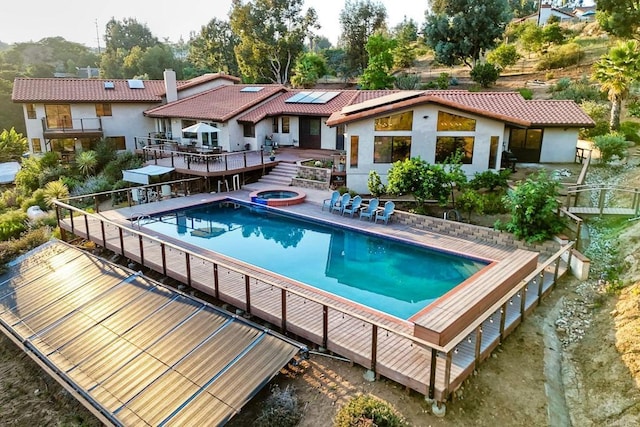 view of swimming pool with a patio area, a wooden deck, and an in ground hot tub