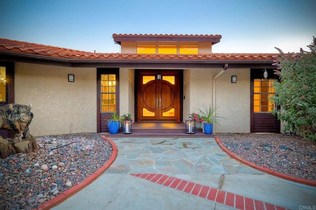 view of exterior entry at dusk