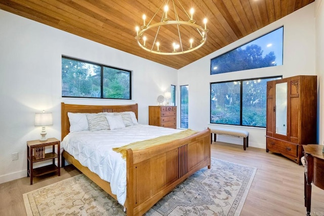 bedroom featuring wooden ceiling, vaulted ceiling, a chandelier, and light hardwood / wood-style flooring