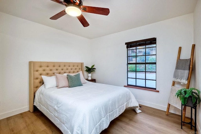 bedroom with ceiling fan and wood-type flooring