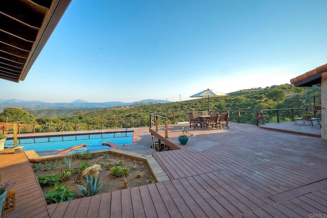 view of swimming pool with a deck with mountain view