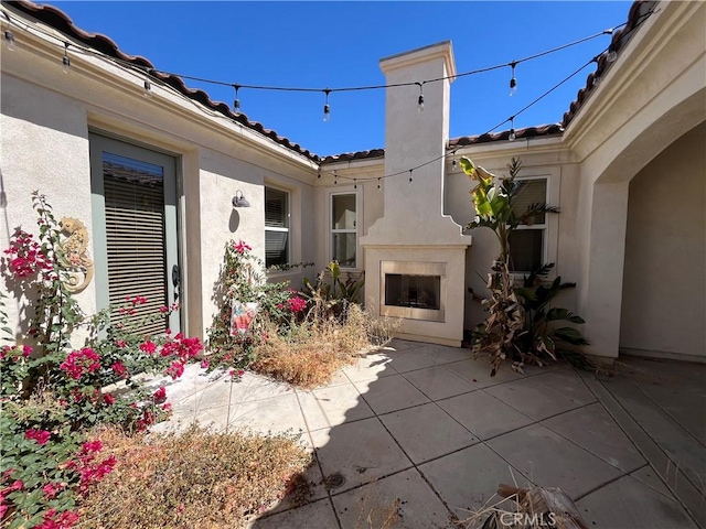 view of patio / terrace with exterior fireplace