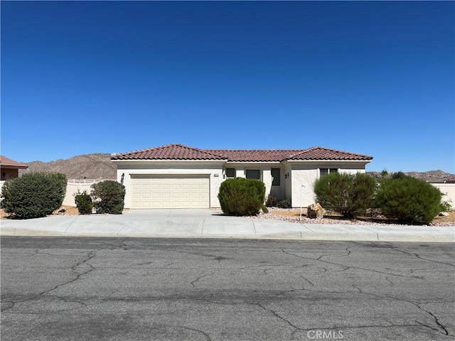 view of front of property with a mountain view and a garage