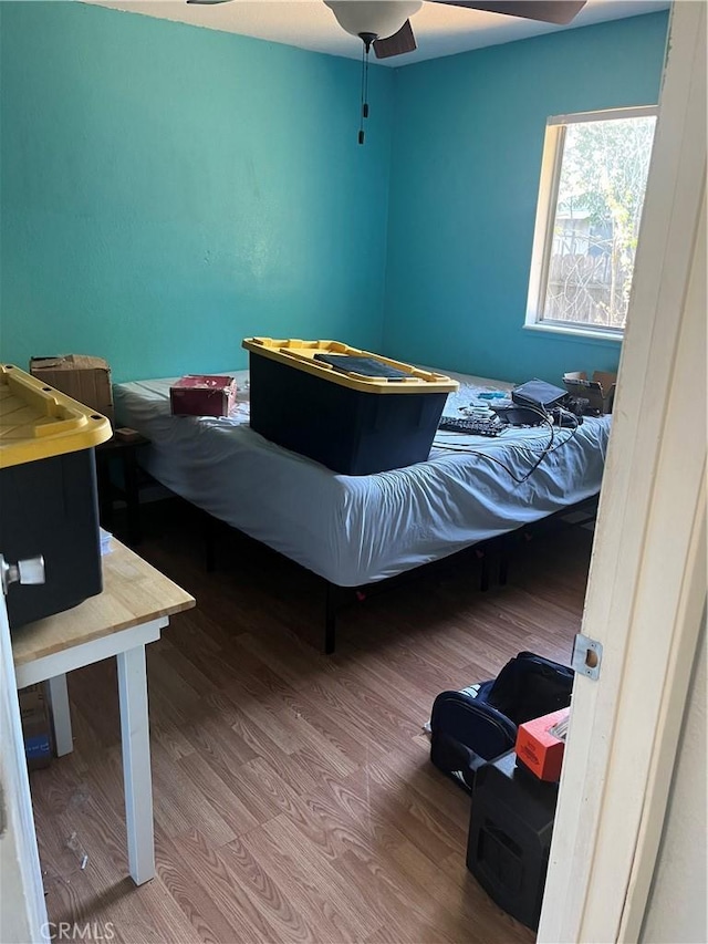 bedroom with wood-type flooring and ceiling fan