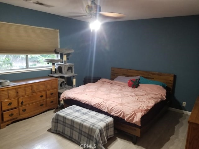 bedroom with light hardwood / wood-style flooring and ceiling fan