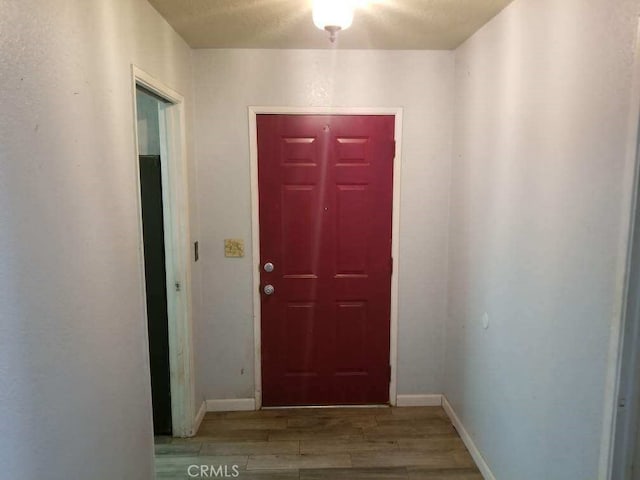 doorway to outside with light wood-type flooring