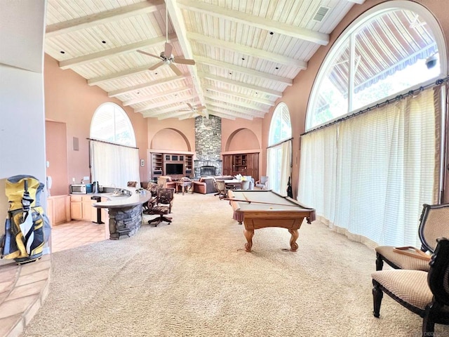 recreation room featuring ceiling fan, high vaulted ceiling, and a wealth of natural light