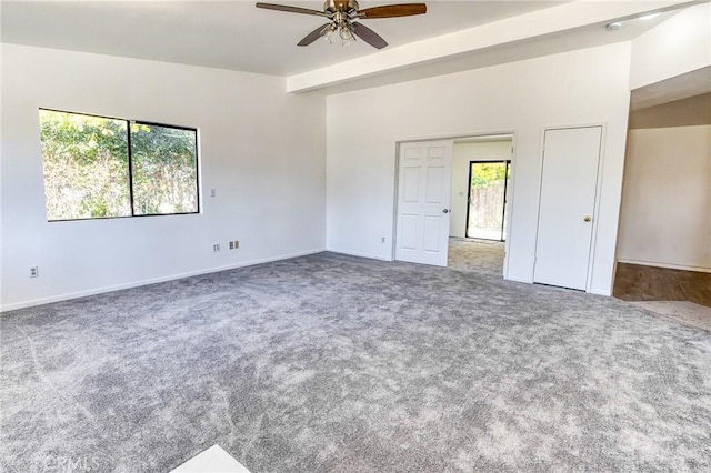 unfurnished room with carpet, ceiling fan, and beamed ceiling