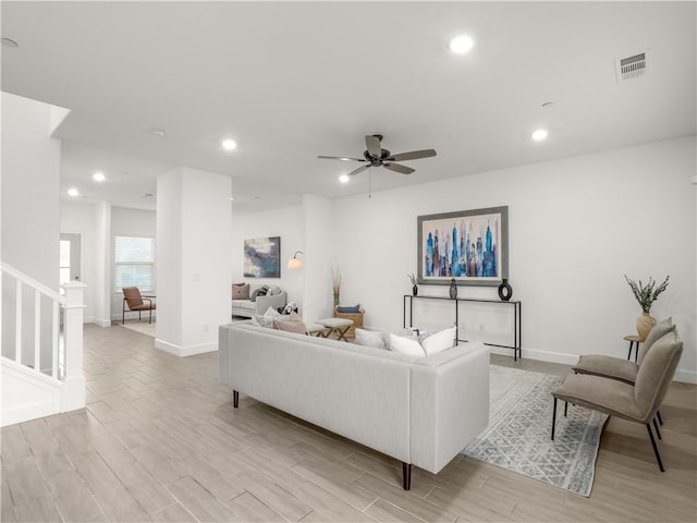 living room with ceiling fan and light wood-type flooring