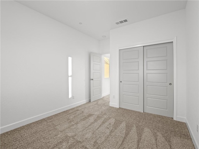 unfurnished bedroom with a closet and carpet floors