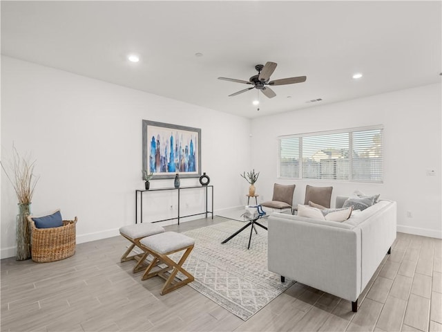 living room with light wood-type flooring and ceiling fan