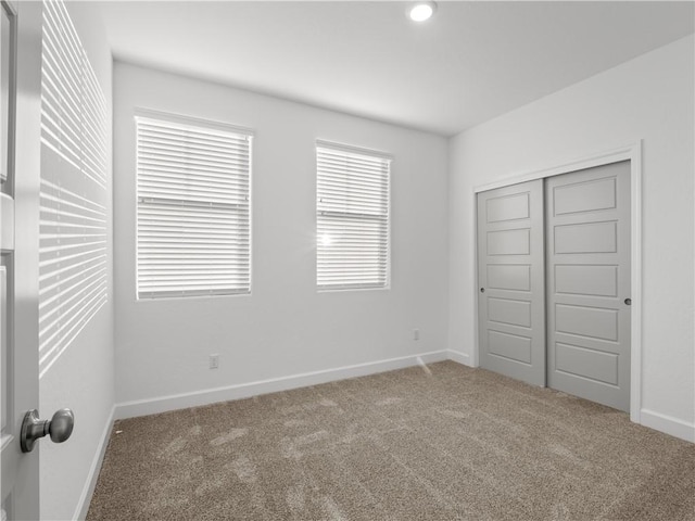 unfurnished bedroom featuring carpet floors and a closet