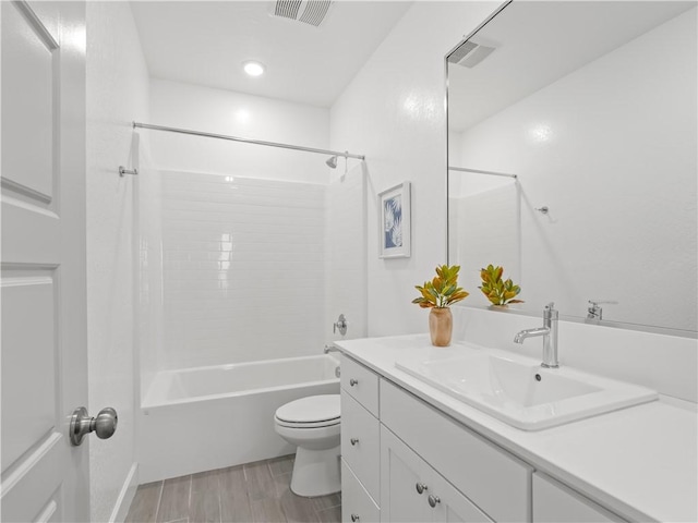 full bathroom with hardwood / wood-style floors, vanity, toilet, and shower / washtub combination