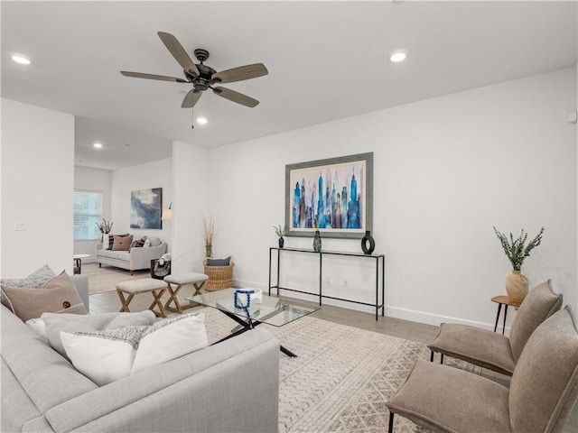 living room featuring ceiling fan and light hardwood / wood-style floors