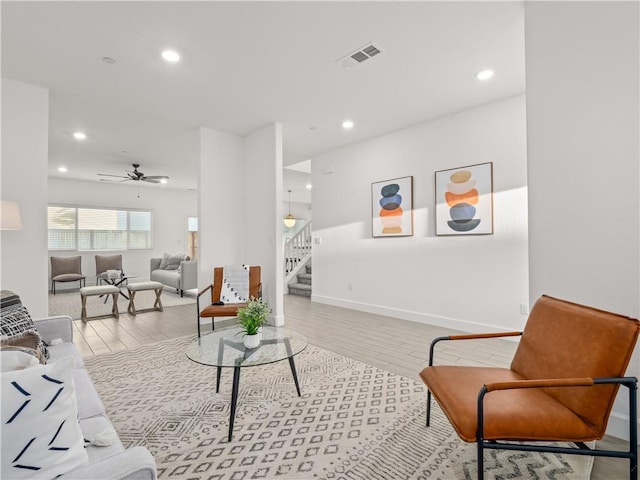 living room featuring ceiling fan and light hardwood / wood-style floors