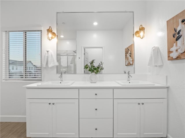 bathroom featuring a shower with door, vanity, and hardwood / wood-style flooring