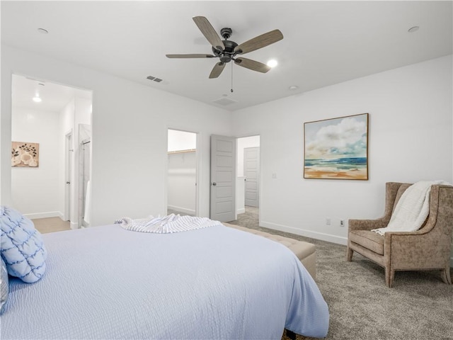 bedroom featuring a walk in closet, ceiling fan, a closet, and light carpet