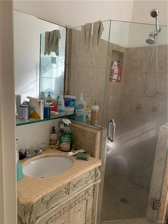 bathroom with vanity and a shower with shower door