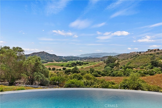 view of swimming pool featuring a mountain view