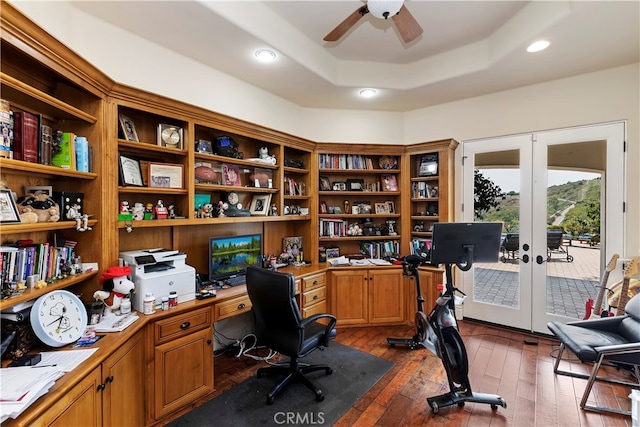 office featuring dark hardwood / wood-style floors, a tray ceiling, french doors, and ceiling fan