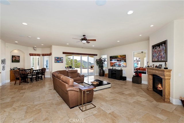 living room with light tile patterned floors and ceiling fan