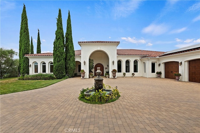 mediterranean / spanish-style home featuring a garage