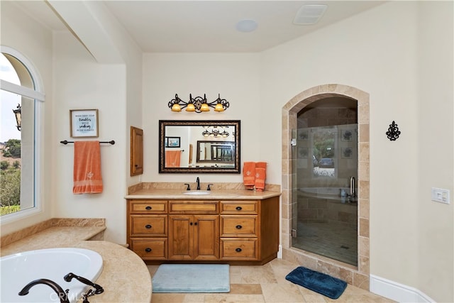 bathroom with tile patterned floors, plus walk in shower, and vanity