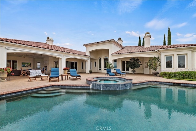 view of pool featuring a patio and an in ground hot tub