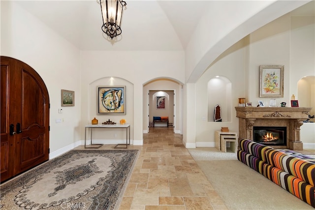 tiled foyer featuring high vaulted ceiling