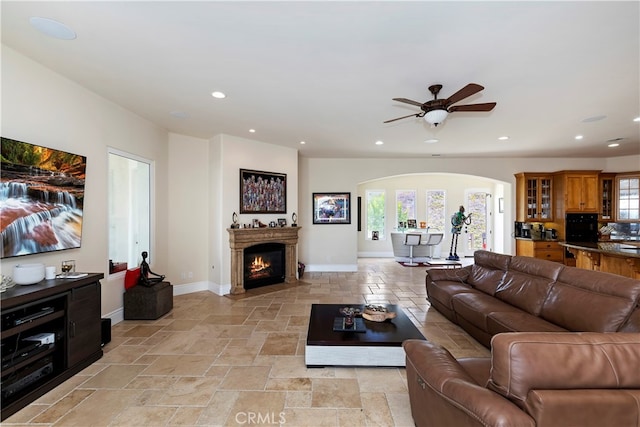 tiled living room featuring ceiling fan