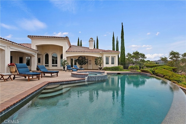 view of pool featuring an in ground hot tub and a patio area