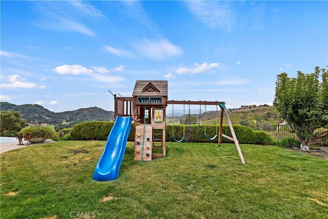 view of play area with a lawn and a mountain view